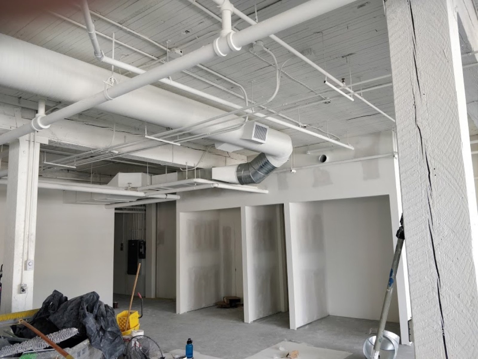 Commercial interior under construction with exposed ducts and overhead services Commercial interior under construction with exposed ducts and overhead services