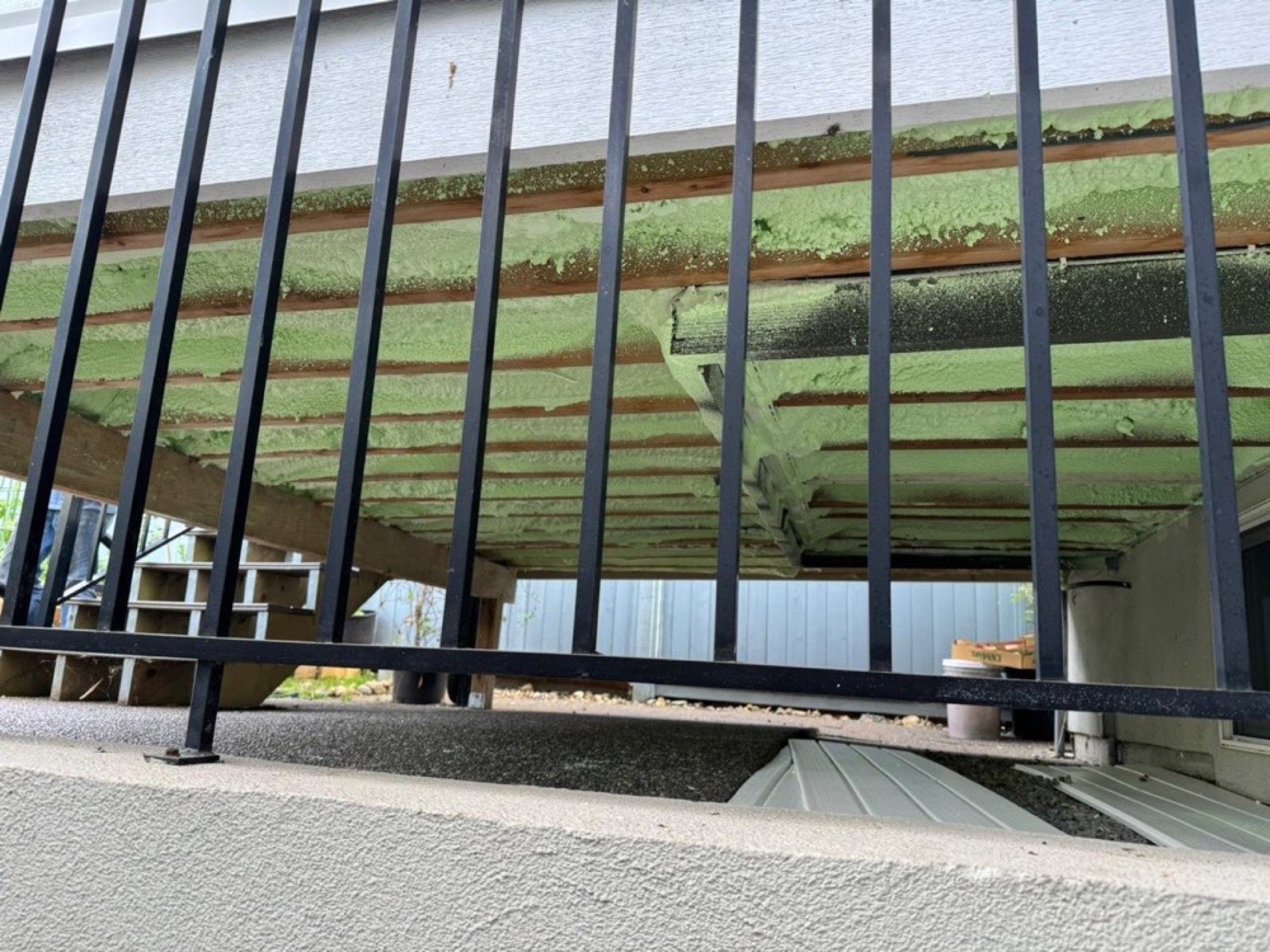 Green insulation visible behind vertical steel framing